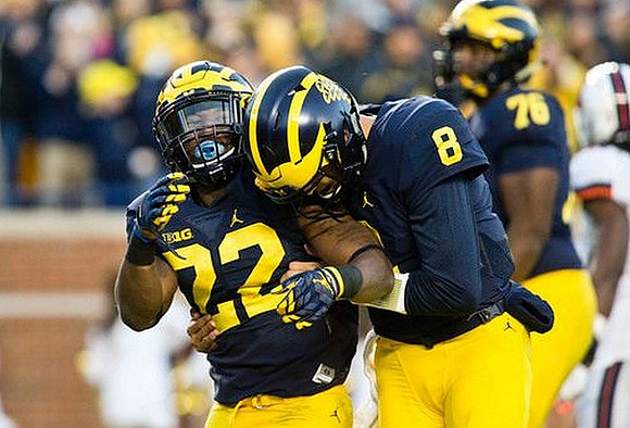 Karan Higdon (22), John O'Korn (8), and Juwann Bushell-Beatty (76)
