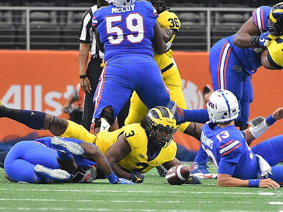 Rashan Gary (3) and Devin Gil (36)