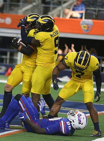 Noah Furbush (59), Mike McCray (9), and Khaleke Hudson (7)