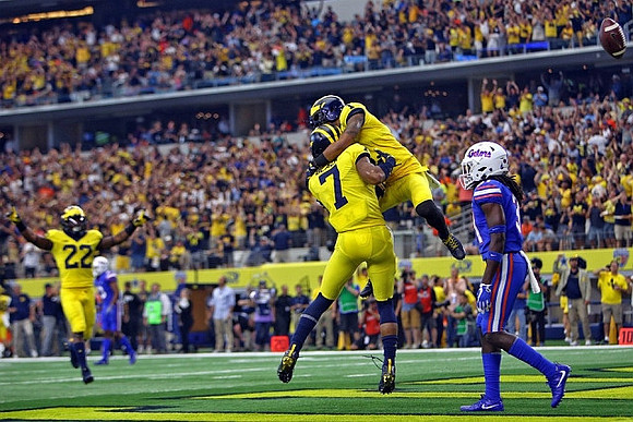 Karan Higdon (22), Tarik Black (7), and Kekoa Crawford (1)