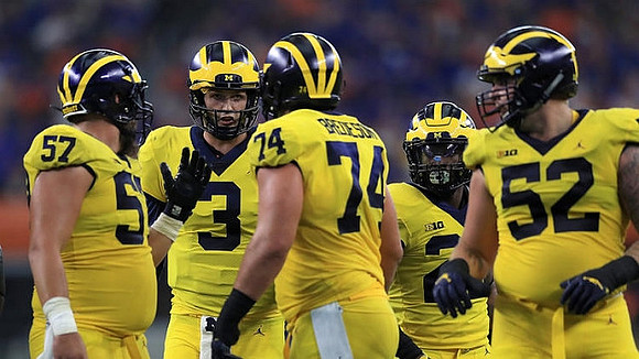 Patrick Kugler (57), Wilton Speight (3), Ben Bredeson (74), Karan Higdon (22), and Mason Cole (52)