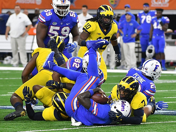 Devin Bush (10) and Khaleke Hudson (7)