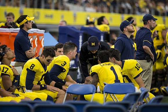 Tyrone Wheatley Jr. (17), John O'Korn (8), Wilton Speight (3), Jim Harbaugh, Kekoa Crawford (1), and Dylan McCaffrey (10)