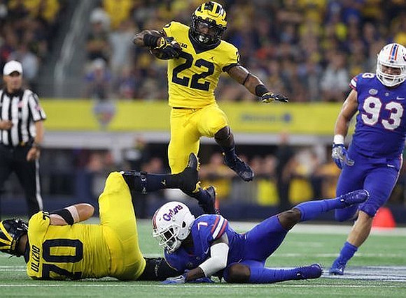 Nolan Ulizio (70) and Karan Higdon (22)