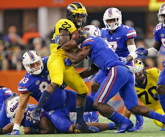 Karan Higdon (22) and Nolan Ulizio (70)