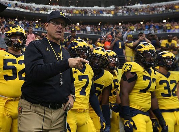 Mason Cole (52), Jim Harbaugh, Maurice Hurst (73), and Ty Isaac (32)