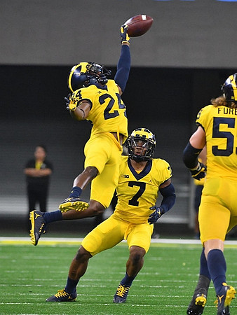Lavert Hill (24), Khaleke Hudson (7), and Noah Furbush (59)