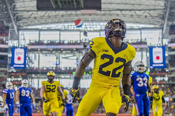 Mason Cole (52), Karan Higdon (22), and Wilton Speight (3)
