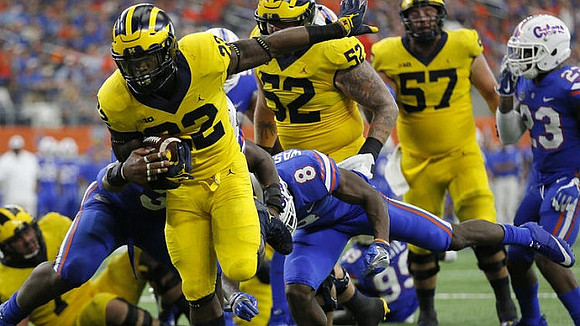 Karan Higdon (22), Mason Cole (52), and Patrick Kugler (57)