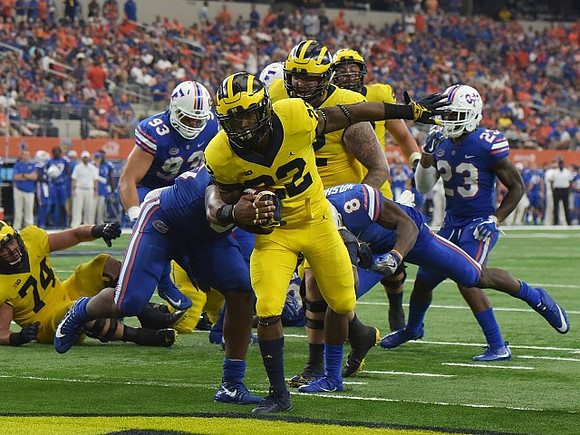 Karan Higdon (22) and Ben Bredeson (74)