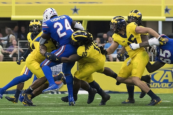 Devin Bush (10) and Chase Winovich (15)