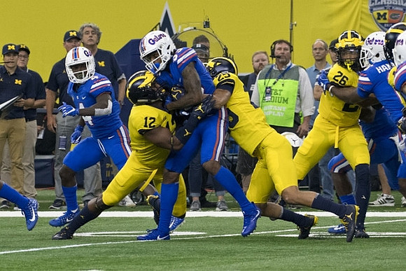 Josh Ross (12), Benjamin St-Juste (25), and J'Marick Woods (26)