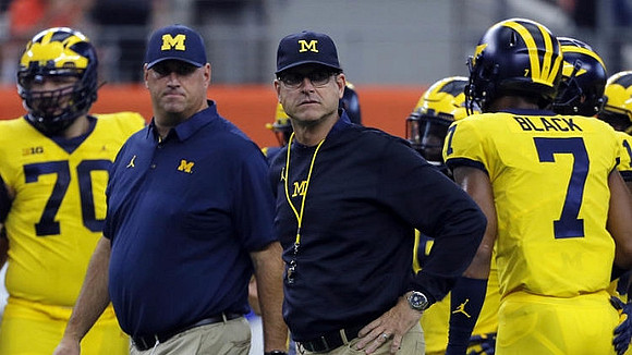 Nolan Ulizio (70), Jim Harbaugh, and Tarik Black (7)