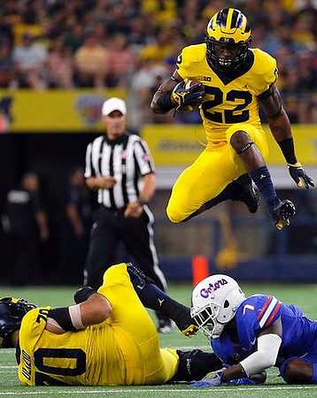 Nolan Ulizio (70) and Karan Higdon (22)