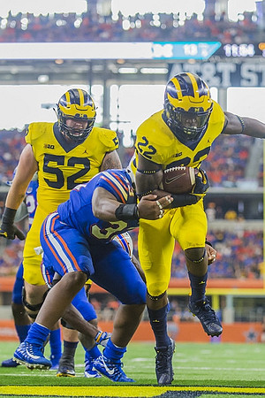 Mason Cole (52) and Karan Higdon (22)