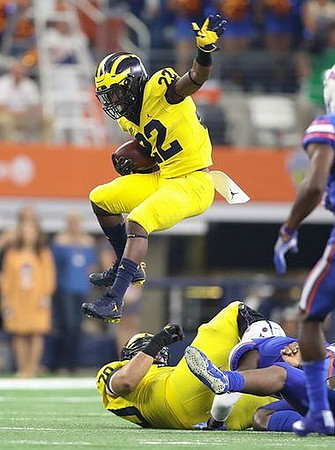 Karan Higdon (22) and Nolan Ulizio (70)