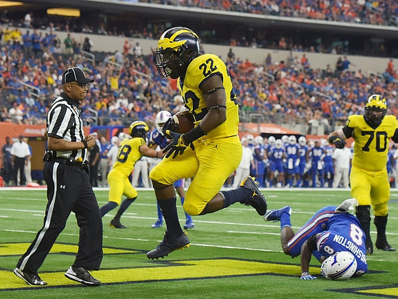 Karan Higdon (22) and Nolan Ulizio (70)