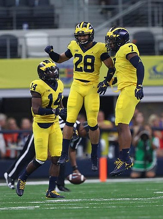 Josh Metellus (14), Brandon Watson (28), and Khaleke Hudson (7)