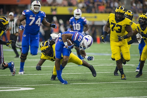 Devin Bush (10) and Maurice Hurst (73)