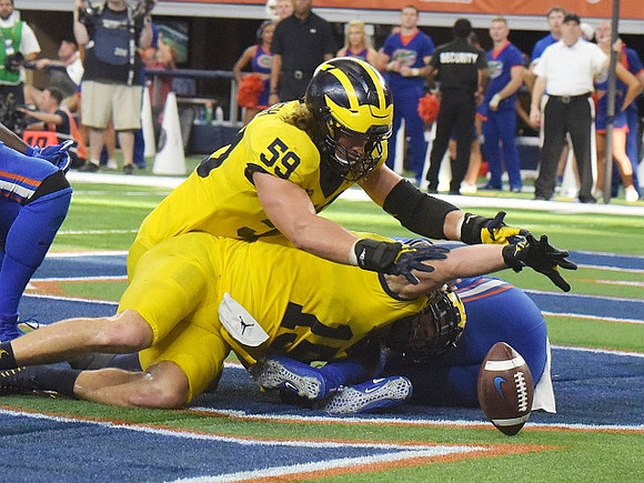 Noah Furbush (59) and Chase Winovich (15)