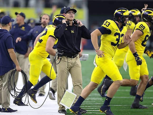 Jim Harbaugh, Camaron Cheeseman (33), and Ian Bunting (89)