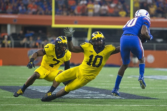 Khaleke Hudson (7) and Devin Bush (10)