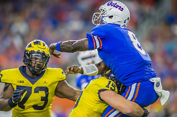 Maurice Hurst (73) and Chase Winovich (15)
