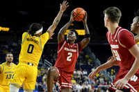 Olivier Nkamhoua (13), Dug McDaniel (0), and Terrance Williams II (5)