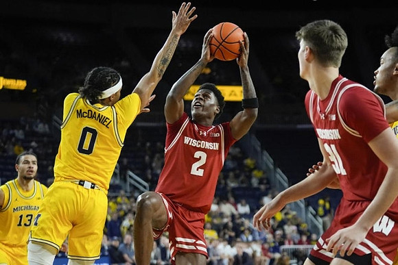 Olivier Nkamhoua (13), Dug McDaniel (0), and Terrance Williams II (5)