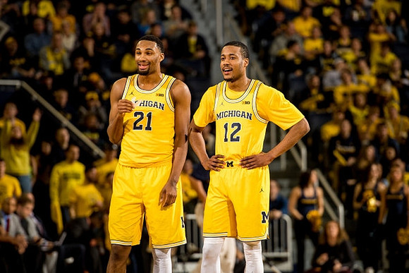 Zak Irvin (21) and Muhammad-Ali Abdur-Rahkman (12)