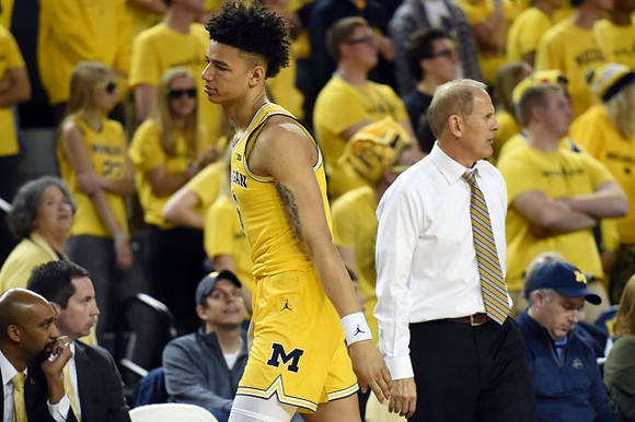 D.J. Wilson (5) and John Beilein