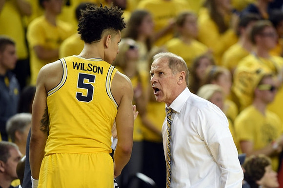 D.J. Wilson (5) and John Beilein