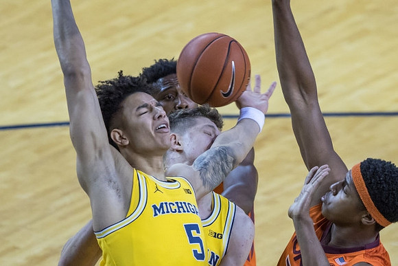 D.J. Wilson (5) and Moritz Wagner (13)