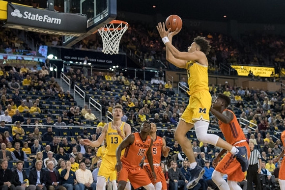 Moritz Wagner (13) and D.J. Wilson (5)