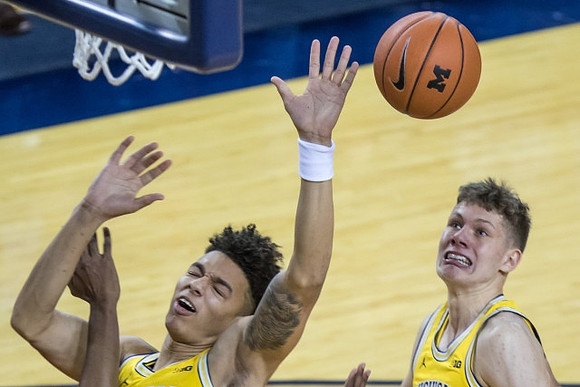 D.J. Wilson (5) and Moritz Wagner (13)