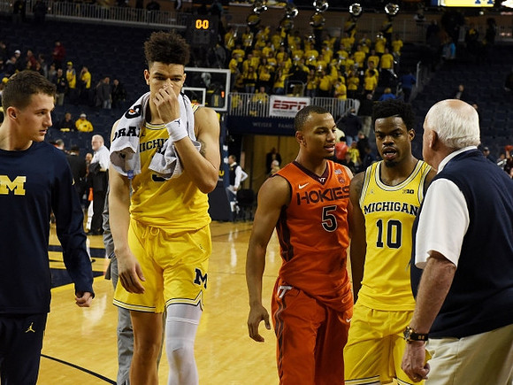 D.J. Wilson (5) and Derrick Walton Jr. (10)