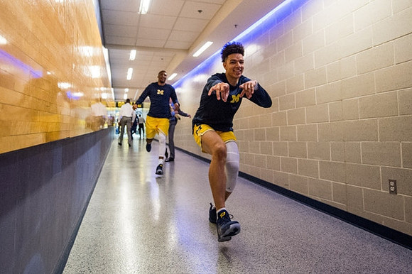 D.J. Wilson (5) and Zak Irvin (21)