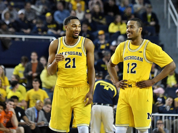 Zak Irvin (21) and Muhammad-Ali Abdur-Rahkman (12)