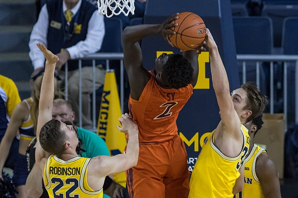 Duncan Robinson (22), Mark Donnal (34), and Derrick Walton Jr. (10)