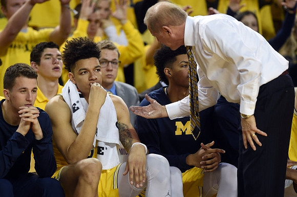 Andrew Dakich (11) , D.J. Wilson (5), John Beilein, and Ibi Watson (23)
