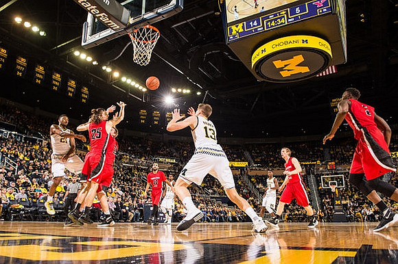 Zak Irvin (21), Moritz Wagner (13), and Caris LeVert (23)