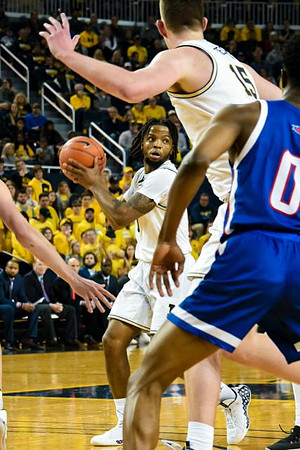 Zavier Simpson (3) and Jon Teske (15)