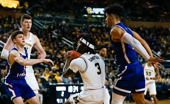 Jon Teske (15), Zavier Simpson (3), and Eli Brooks (55)