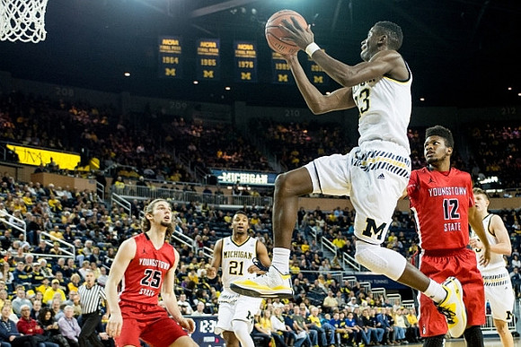 Zak Irvin (21), Caris LeVert (23), and Moritz Wagner (13)