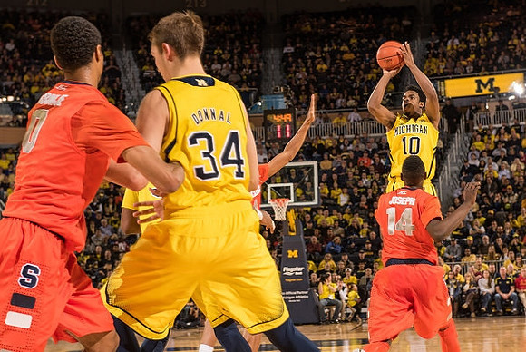 Mark Donnal (34) and Derrick Walton Jr. (10)