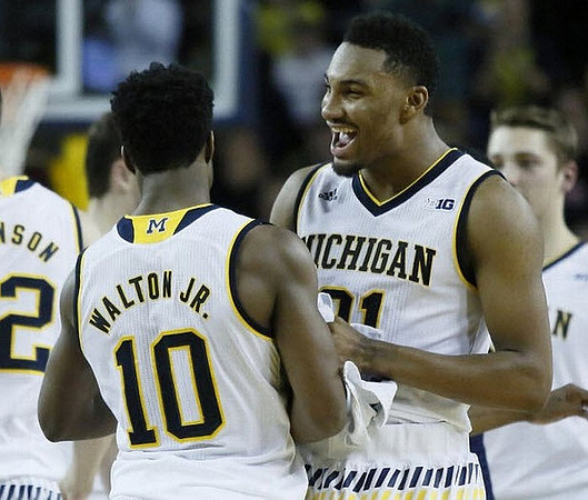 Derrick Walton Jr. (10) and Zak Irvin (21)