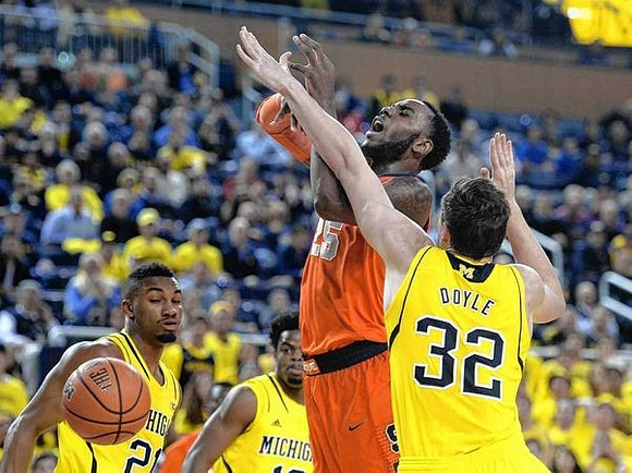 Zak Irvin (21), Derrick Walton Jr. (10), and Ricky Doyle (32)