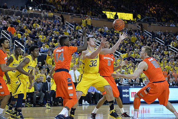 Caris LeVert (23), Derrick Walton Jr. (10), and Ricky Doyle (32)