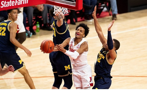 Caleb Houstan (22), Brandon Johns Jr. (23), and DeVante' Jones (12)