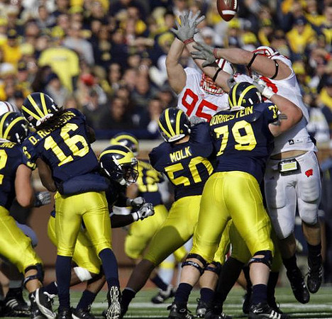 Denard Robinson (16), David Molk (50), and Perry Dorrestein (79)